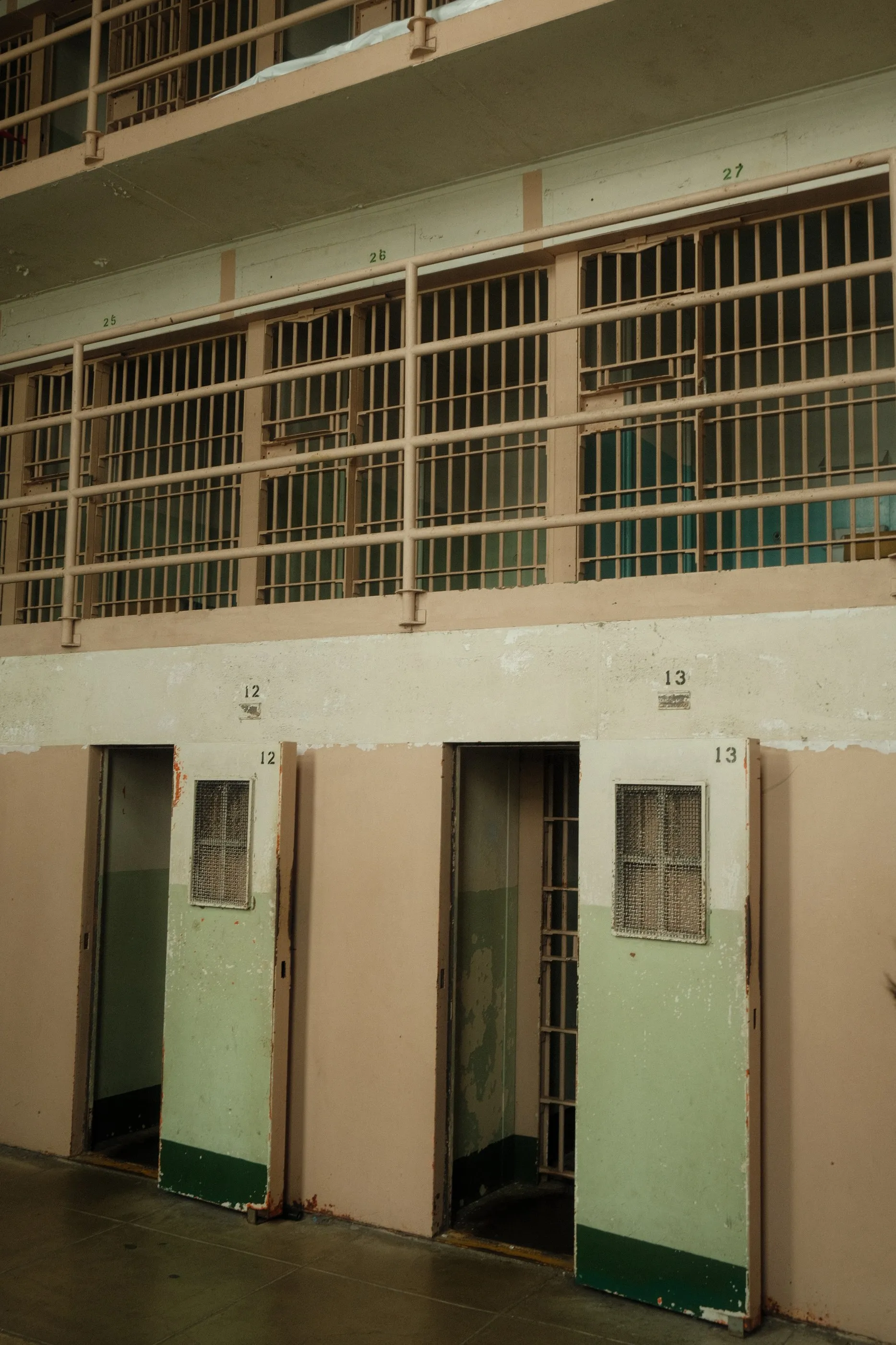 A weathered corridor of barred cells at Alcatraz
